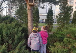 Dzieci obserwujące przyrodę w ogrodzie.